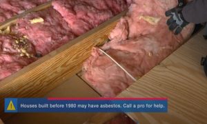 Kitchener Affordable Roofing worker installing attic insulation