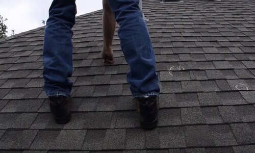 Kitchener Affordable Roofing worker doing a roof inspection